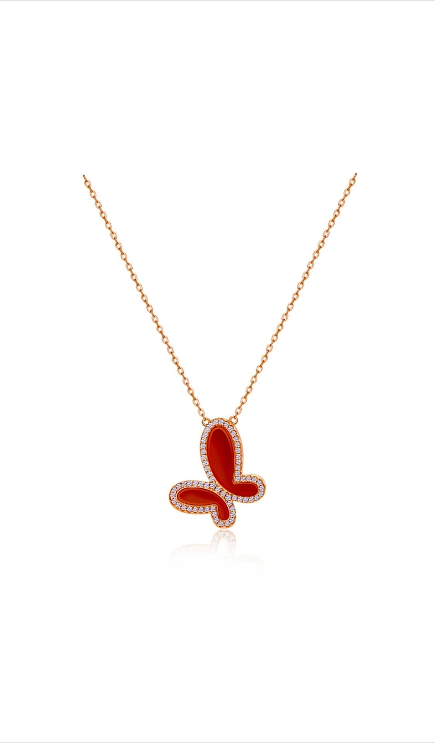Red butterfly pendant necklace on a white background