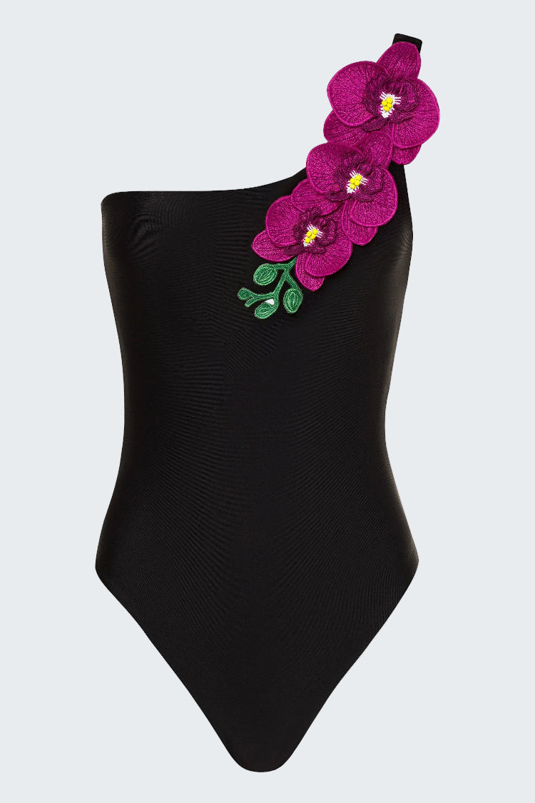 Black one-shoulder swimsuit with pink floral embellishments on a white background