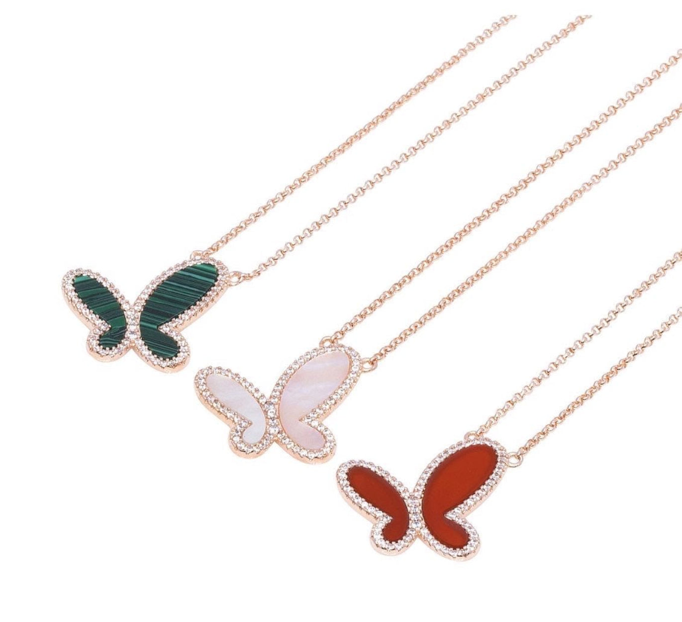 Butterfly-shaped pendants on gold chains against a white background