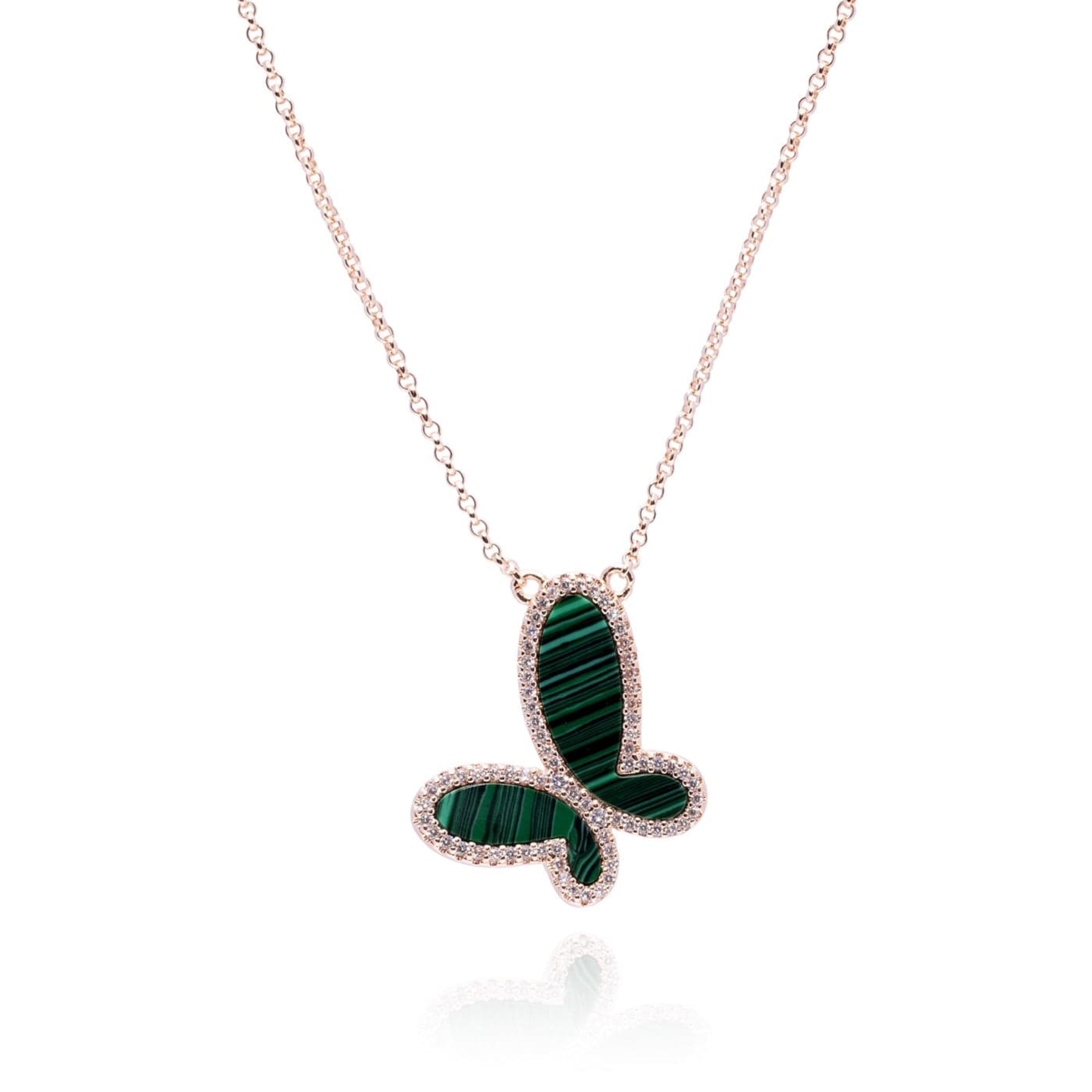Butterfly-shaped necklace with green gemstones on a white background
