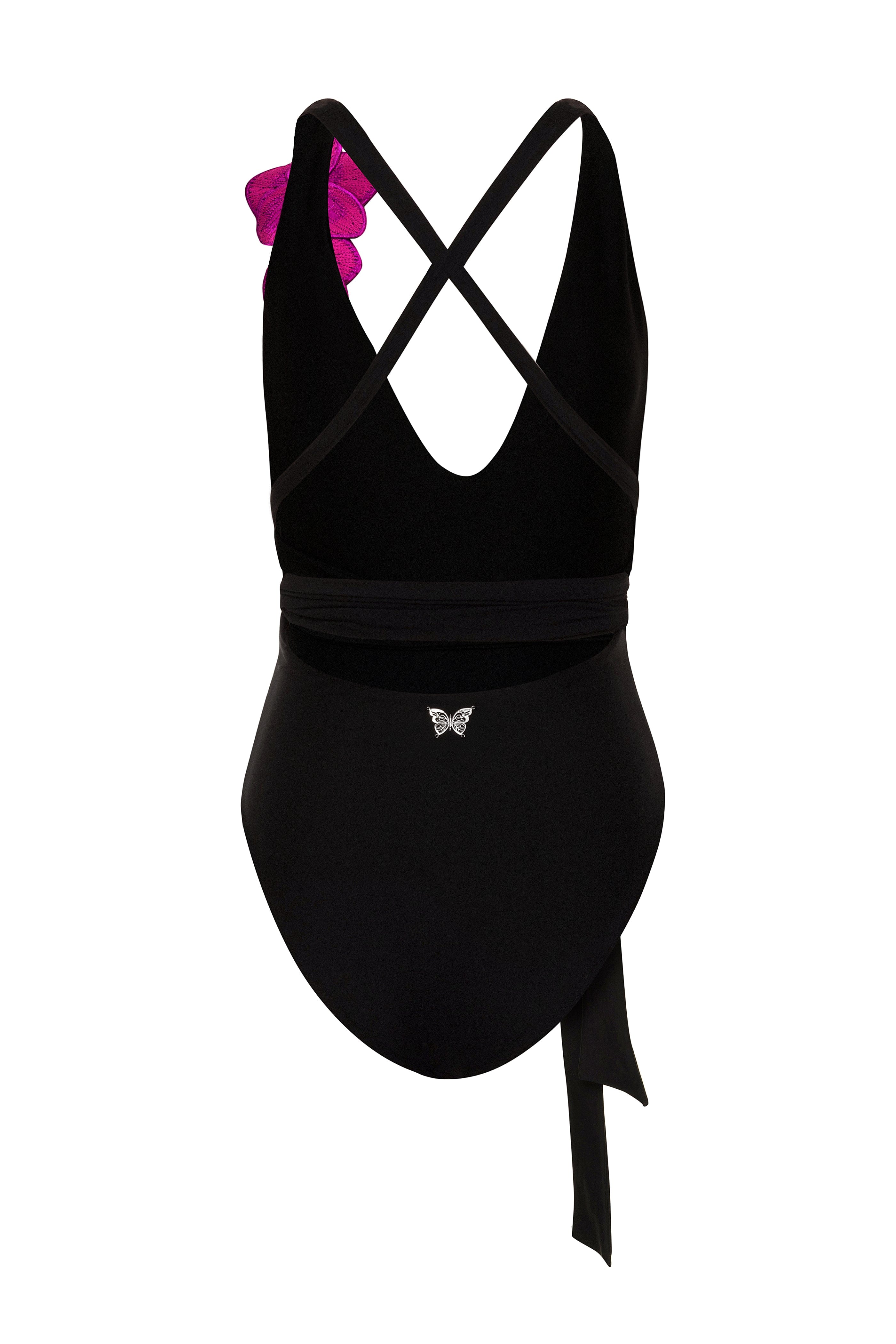 Black swimsuit with criss-cross straps and a bow on a white background