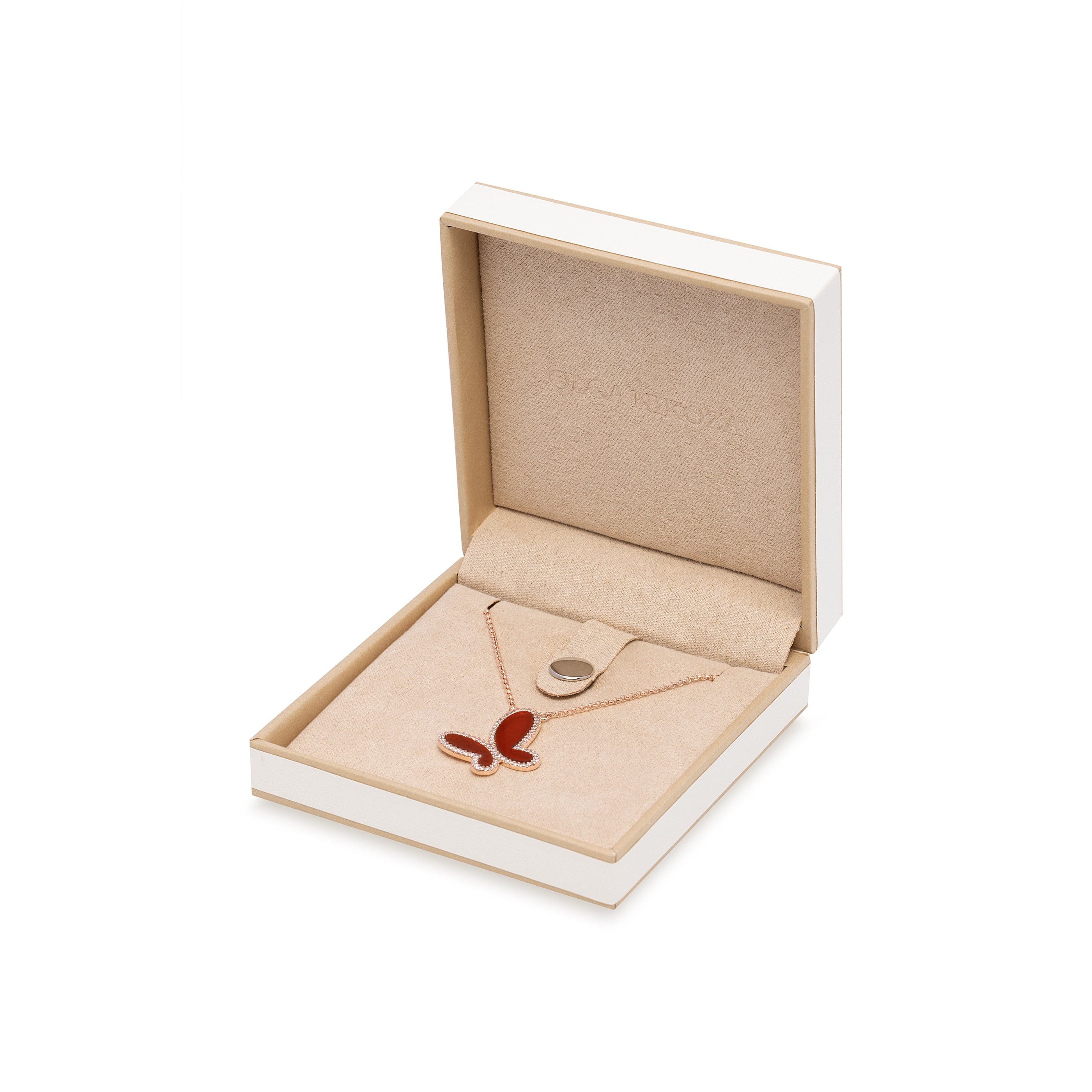 Necklace with a red pendant in an open jewelry box on a white background