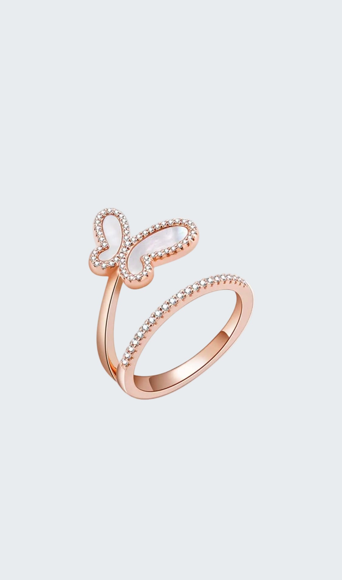 Rose gold butterfly ring with white gemstone on a white background