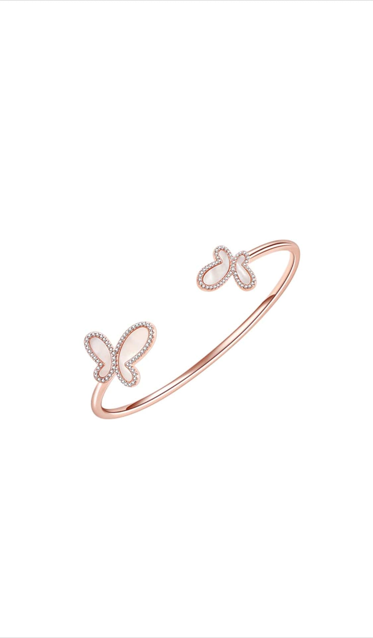 Rose gold bracelet with butterfly designs on a white background