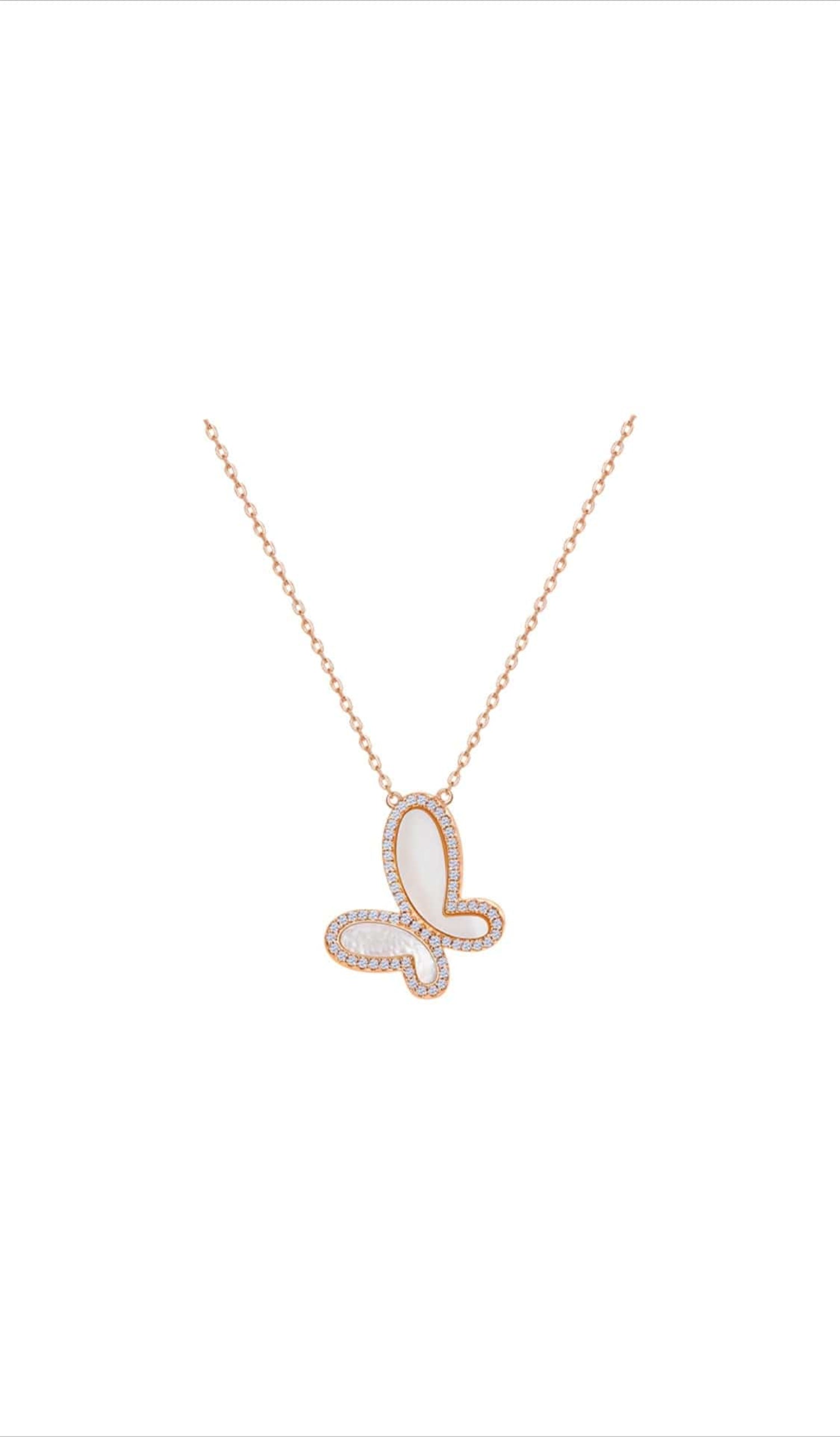 Butterfly-shaped necklace with rose gold chain on a white background