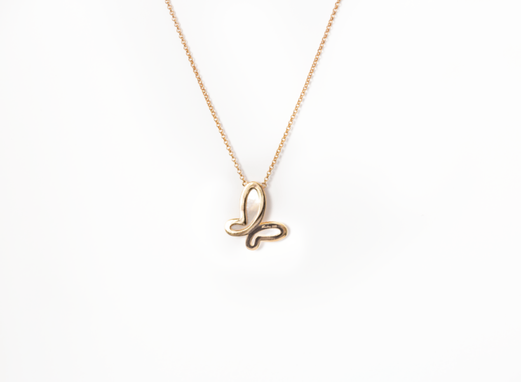 Gold butterfly necklace on a white background