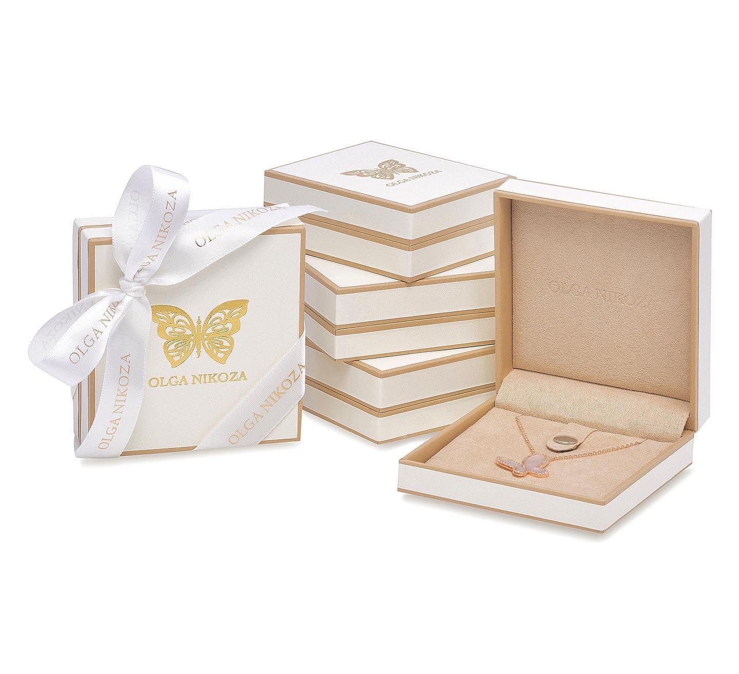 Jewelry box with a necklace and packaging featuring 'Olga Nikolova' brand on a white background