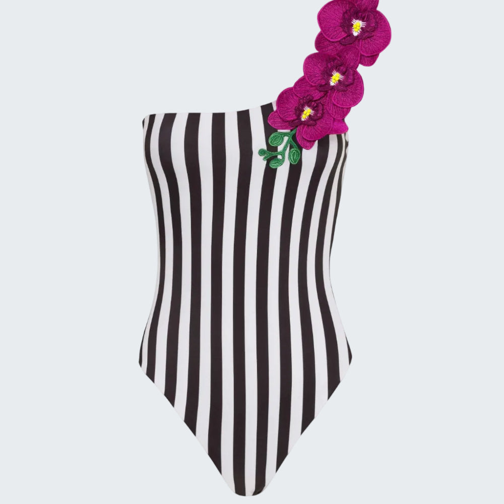 Black and white striped swimsuit with pink flowers on a white background