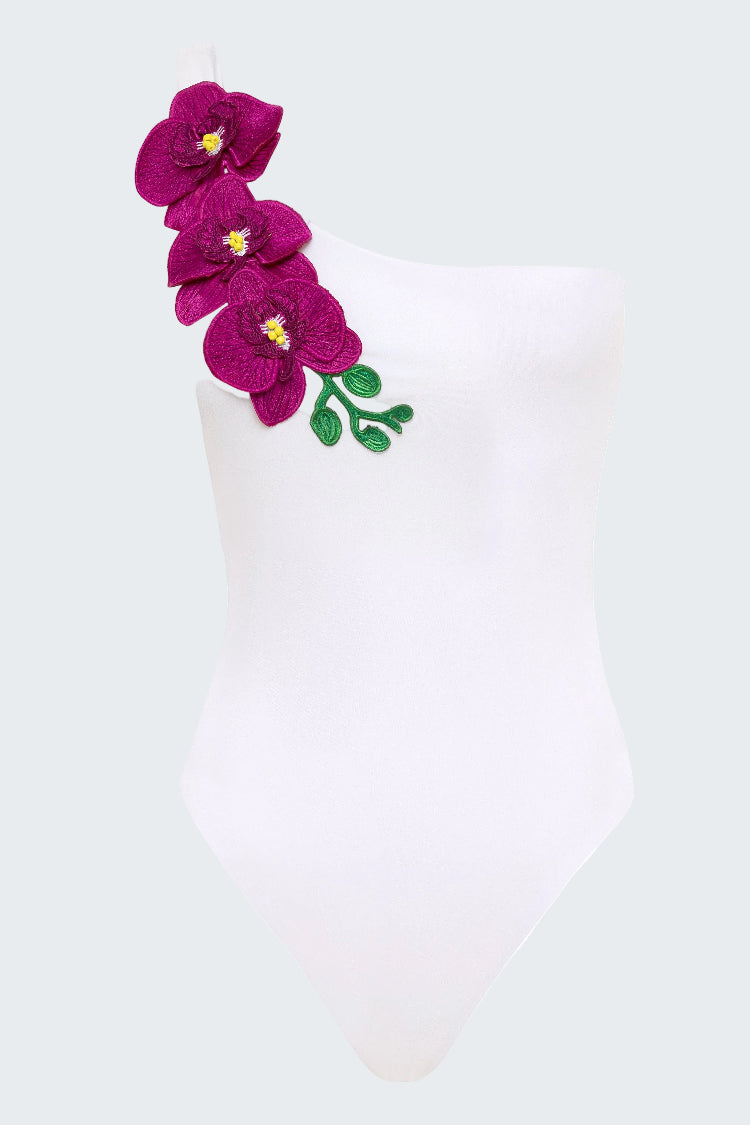 White swimsuit with purple floral design on a white background