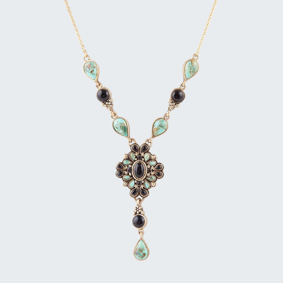 Necklace with turquoise and black gemstones on a white background