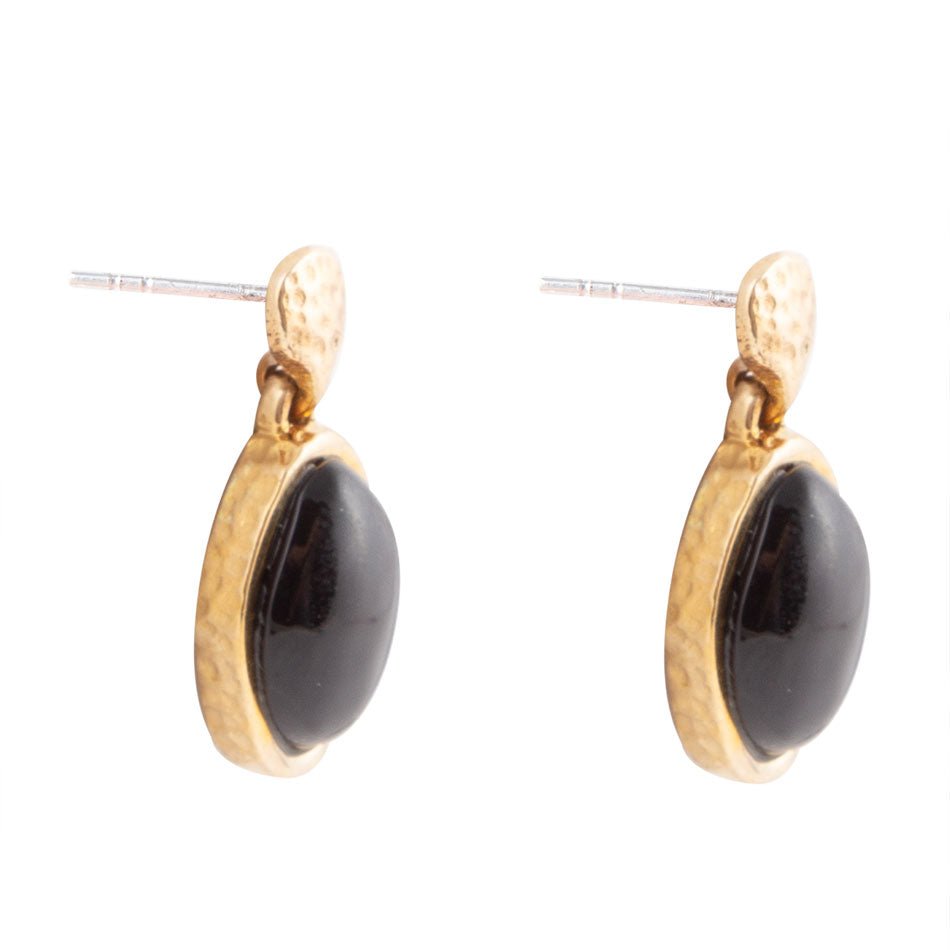 Gold earrings with black stones on a white background