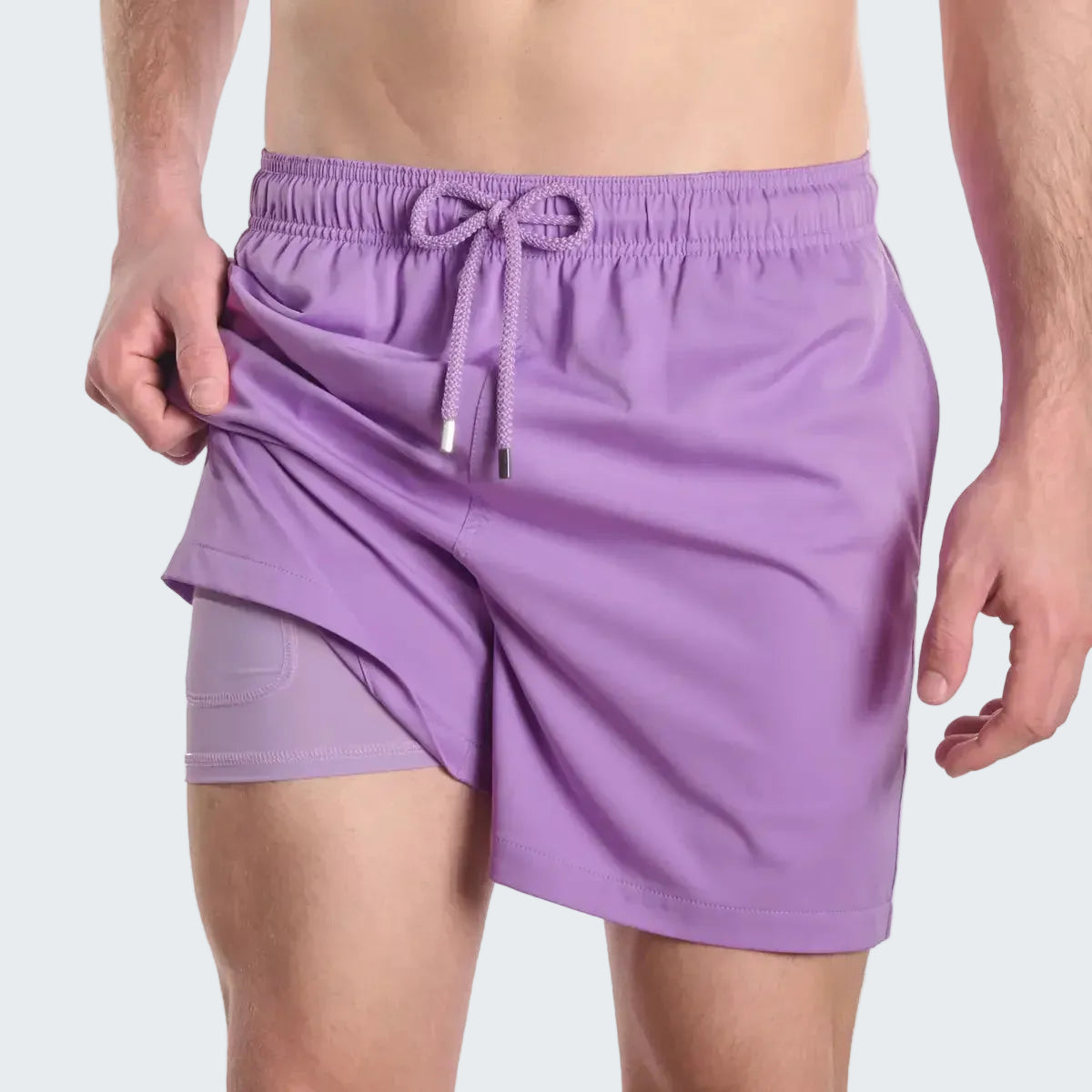 Purple athletic shorts with a drawstring on a white background
