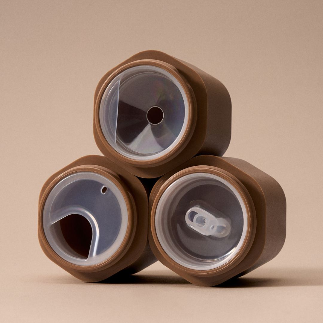 Three brown and gray cylindrical objects stacked on a beige background