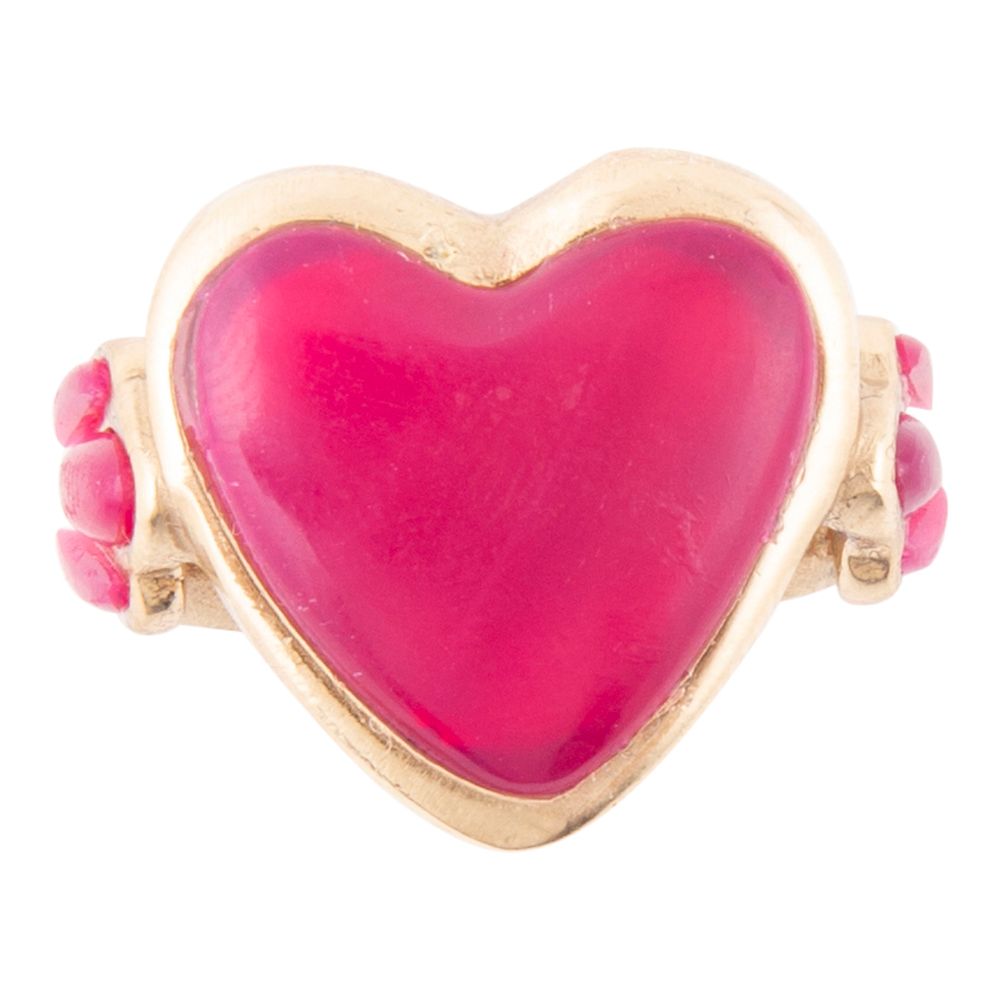 Heart-shaped pink stone ring with gold band on a white background