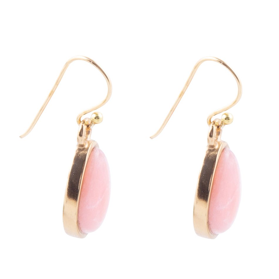 Gold earrings with pink oval stones on a white background