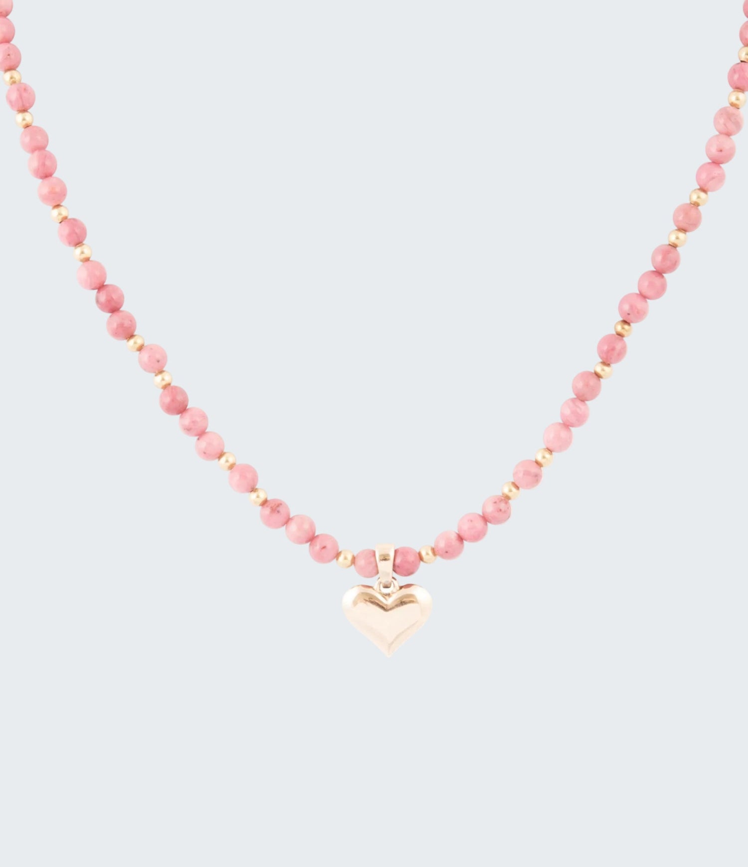 Necklace with pink beads and a heart-shaped pendant on a white background