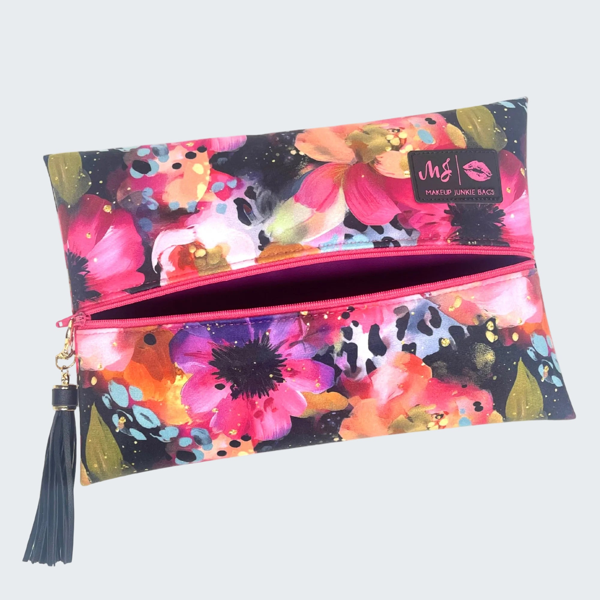 Floral patterned makeup bag with a tassel on a white background