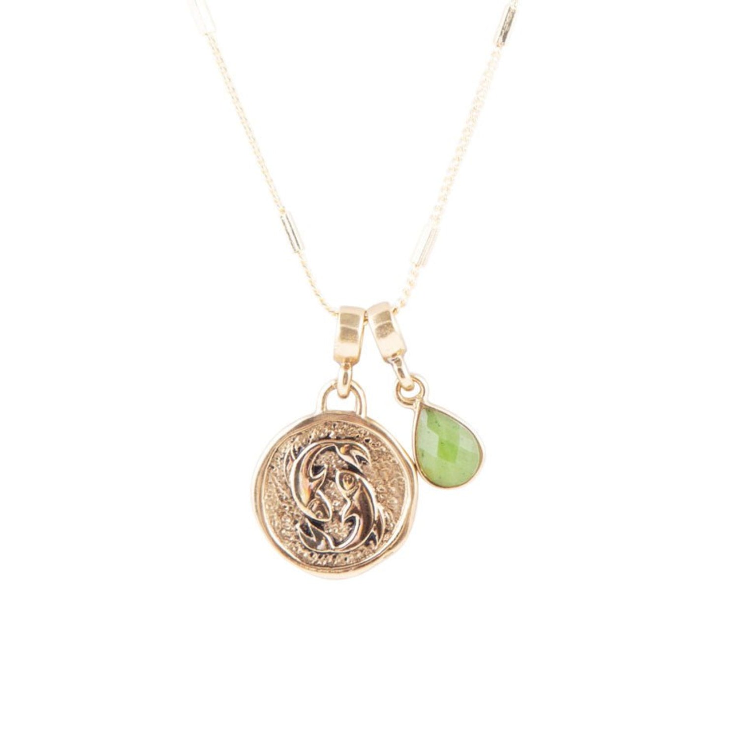 Gold necklace with a green pendant on a white background