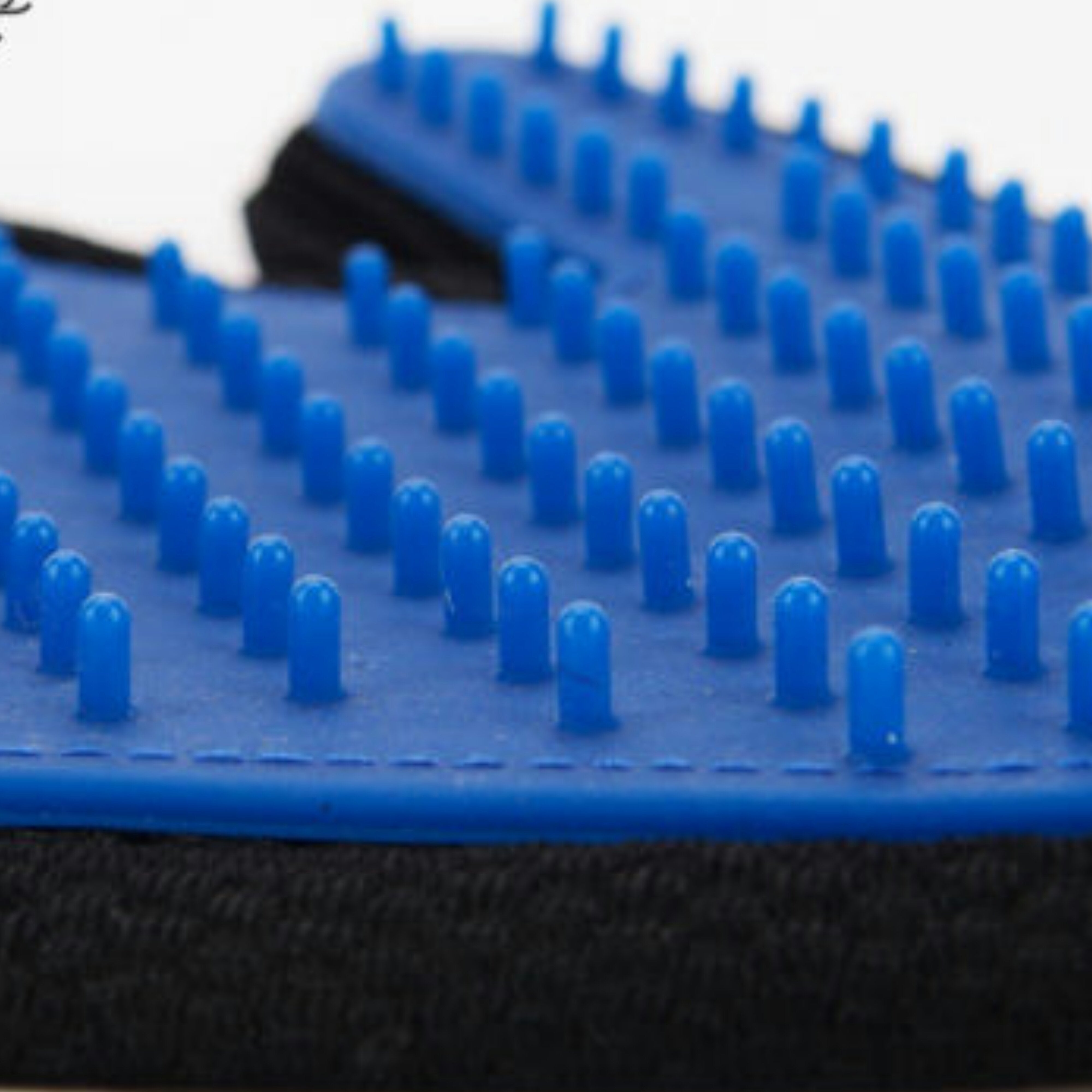 Blue grooming brush with black handle on a white background
