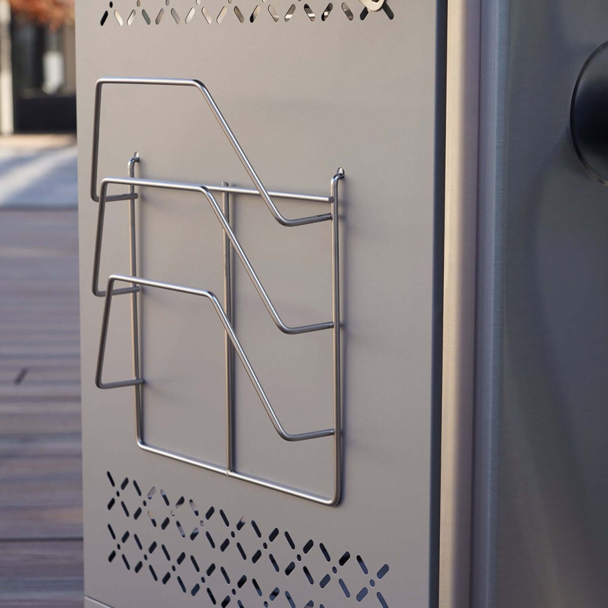 Metal wire holder on a metallic surface with a blurred background