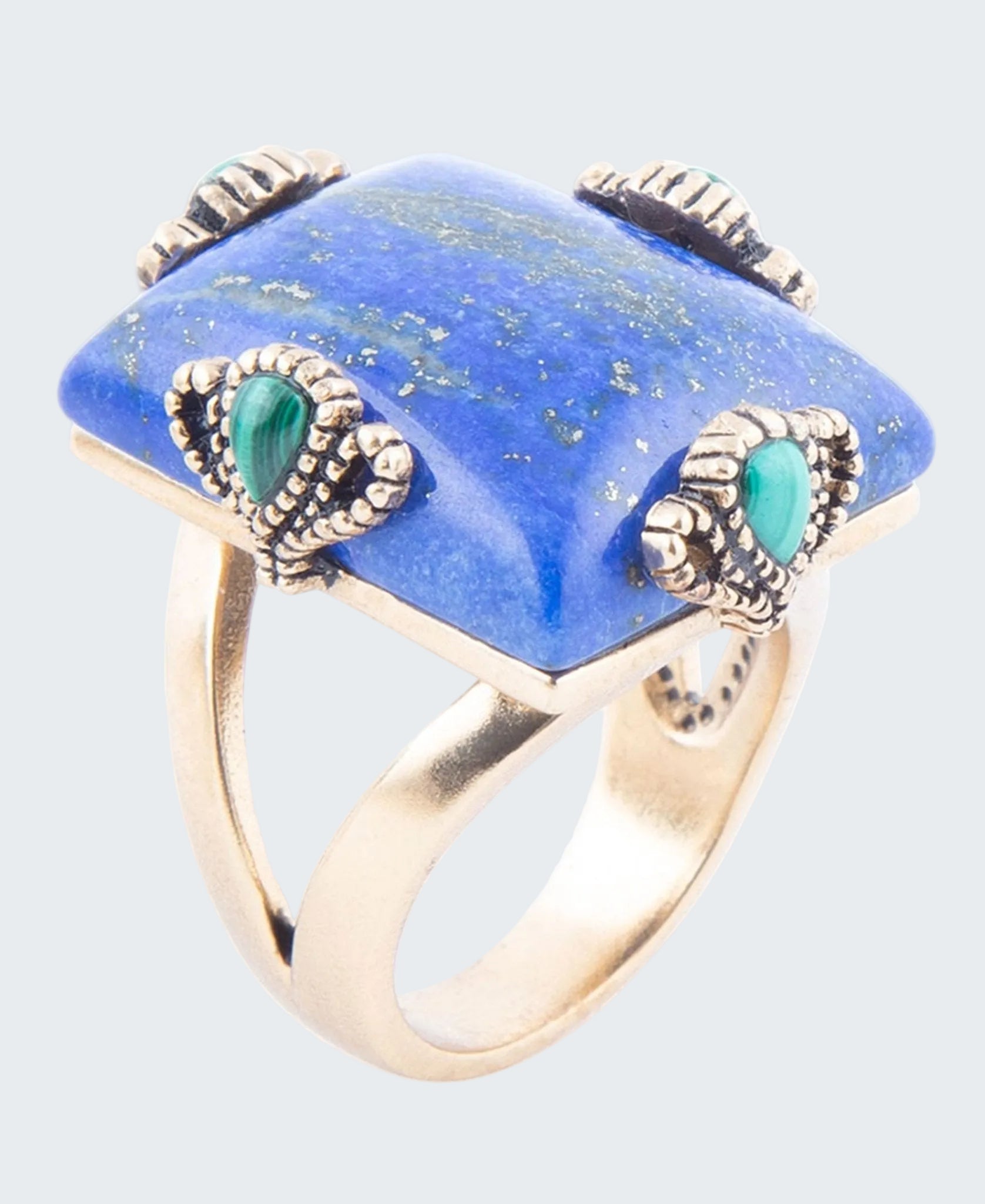 Ring with blue stone and green accents on a white background