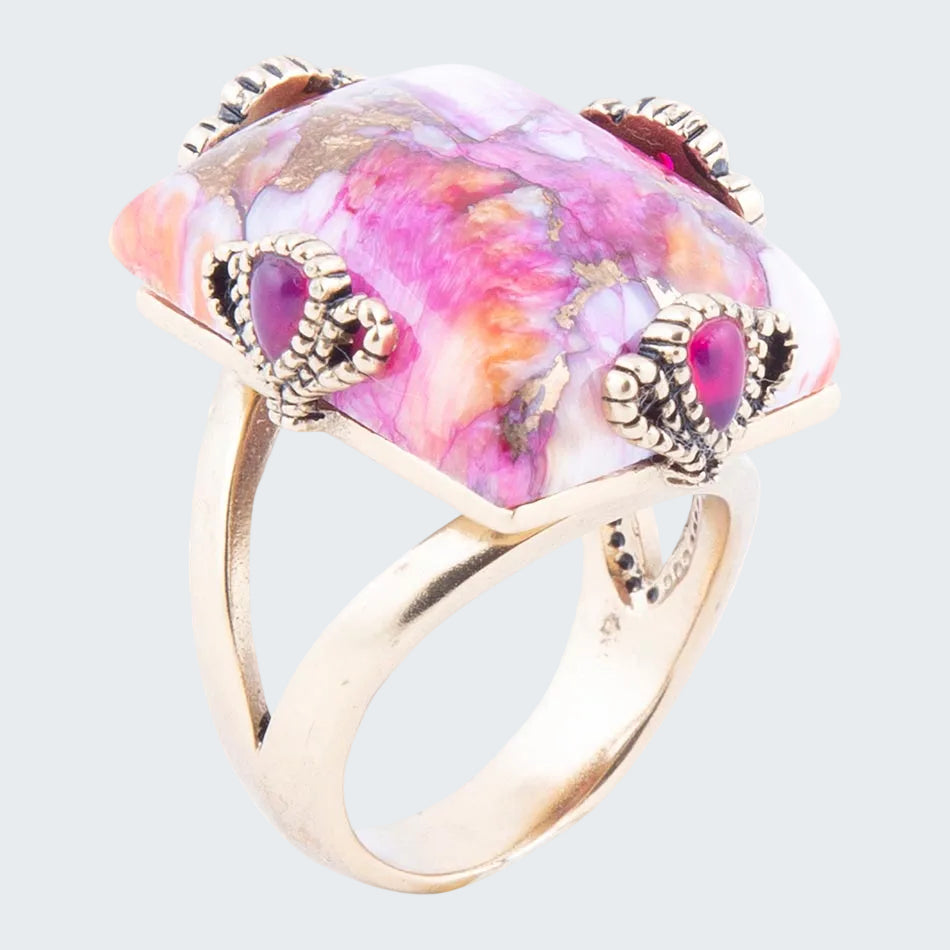 Ring with a colorful gemstone and gold accents on a white background