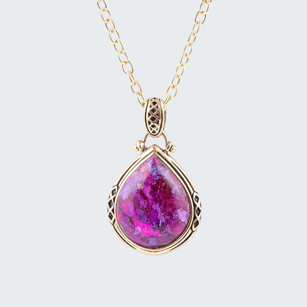 Necklace with a teardrop-shaped pink gemstone pendant on a white background