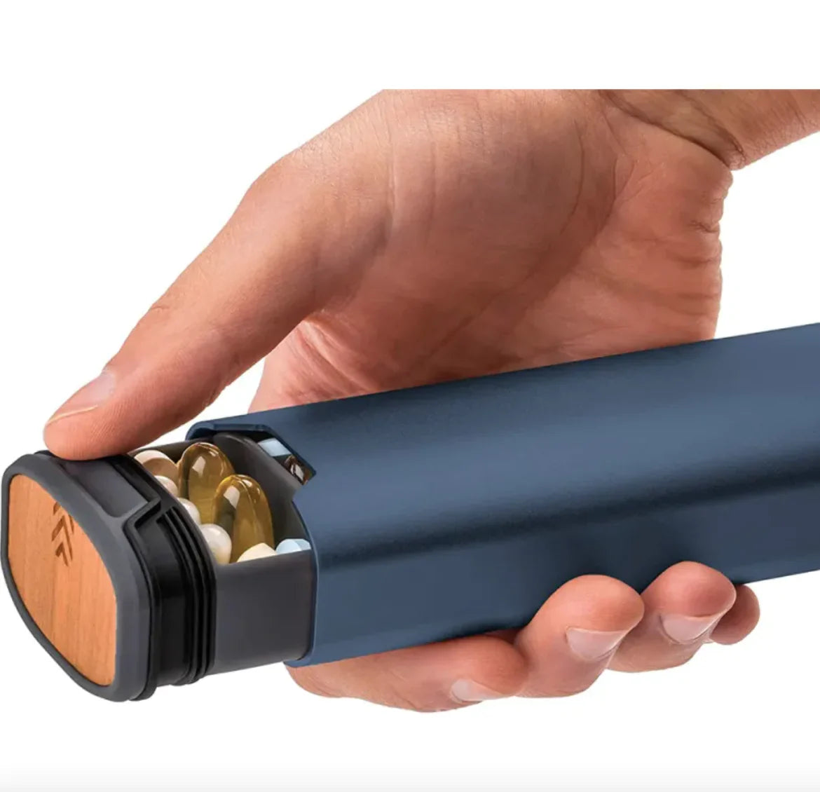 Hand holding a blue and black cylindrical container with wooden accents.