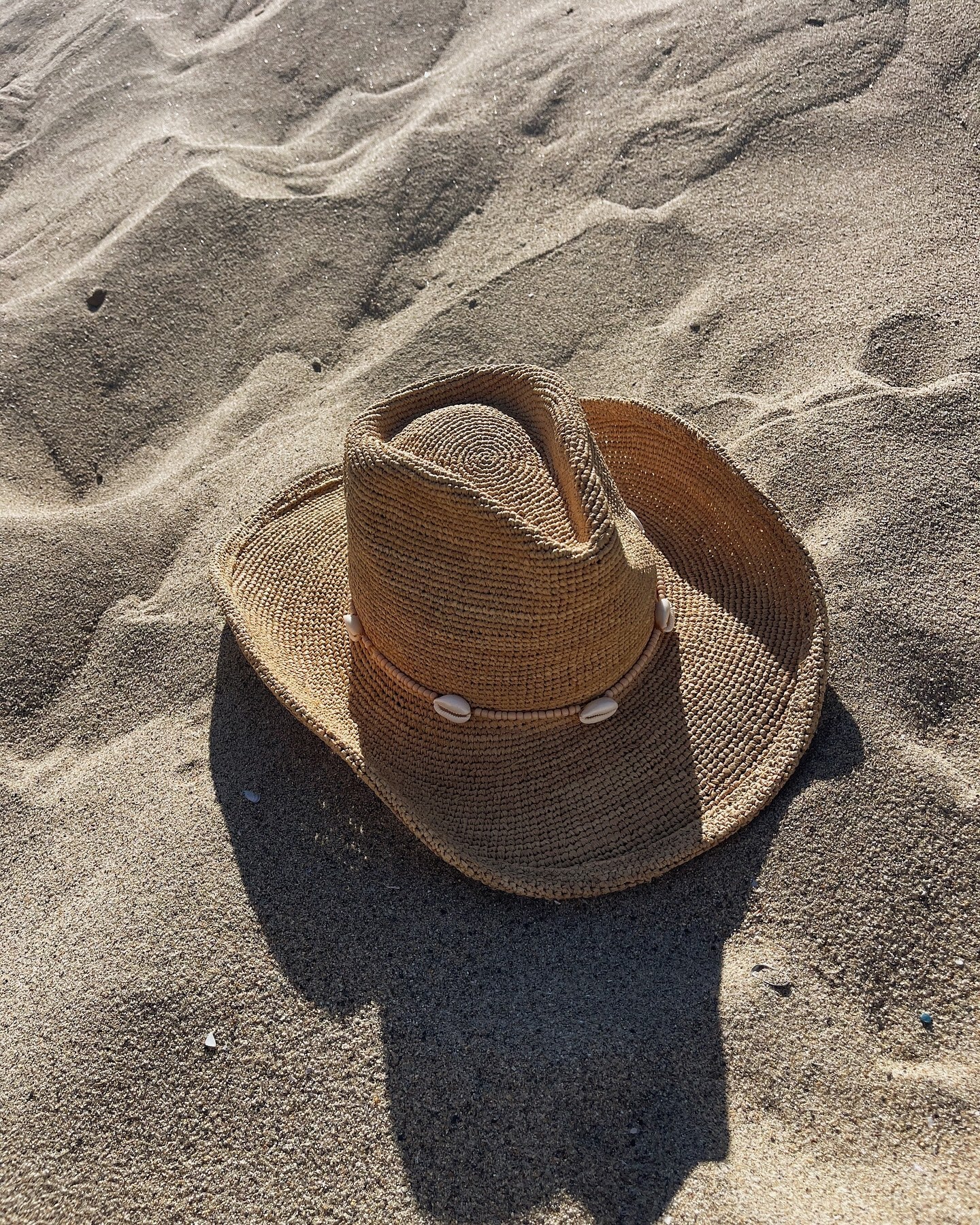Brown straw hat on sand