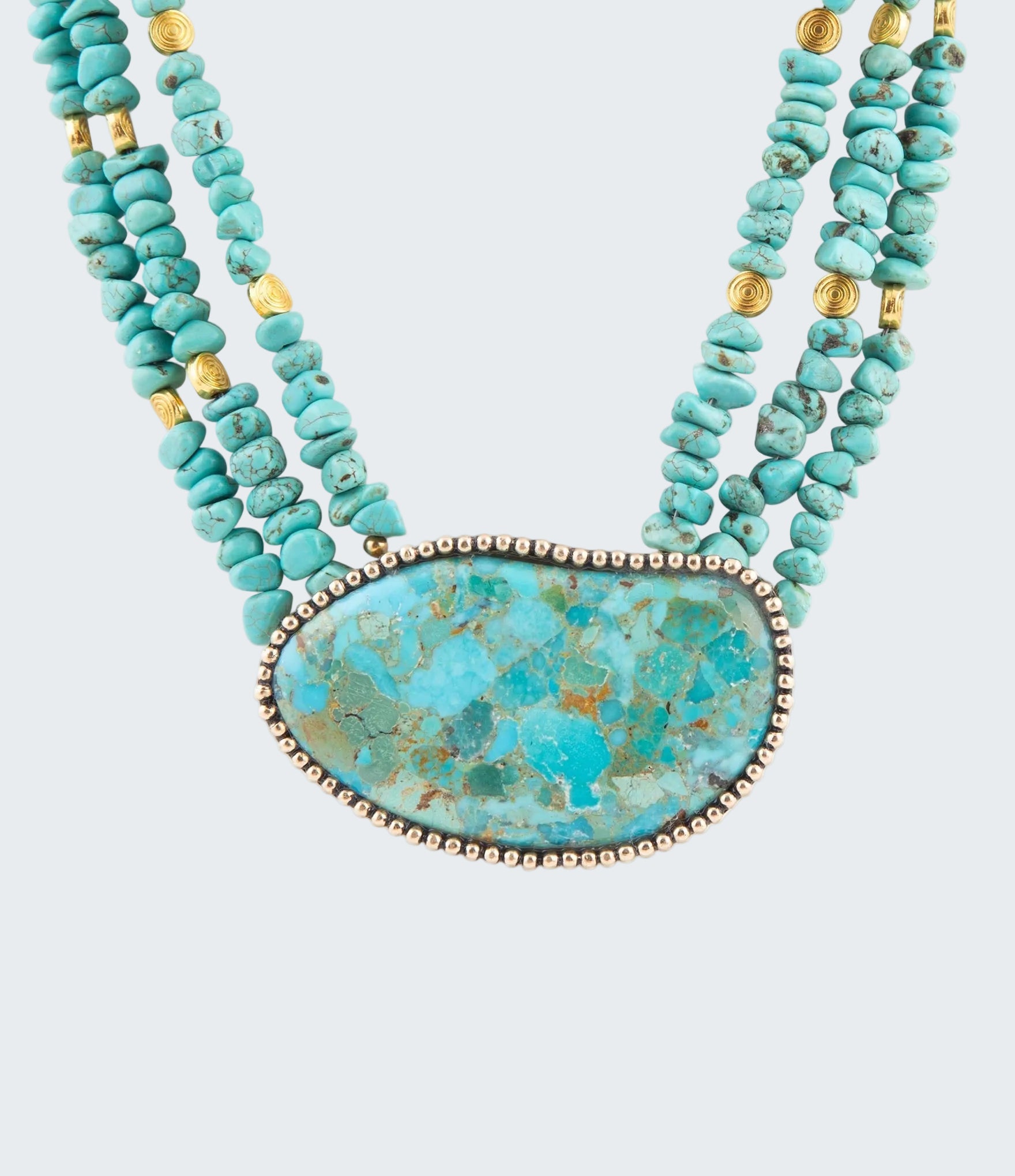 Turquoise beaded necklace with a large turquoise stone pendant on a white background