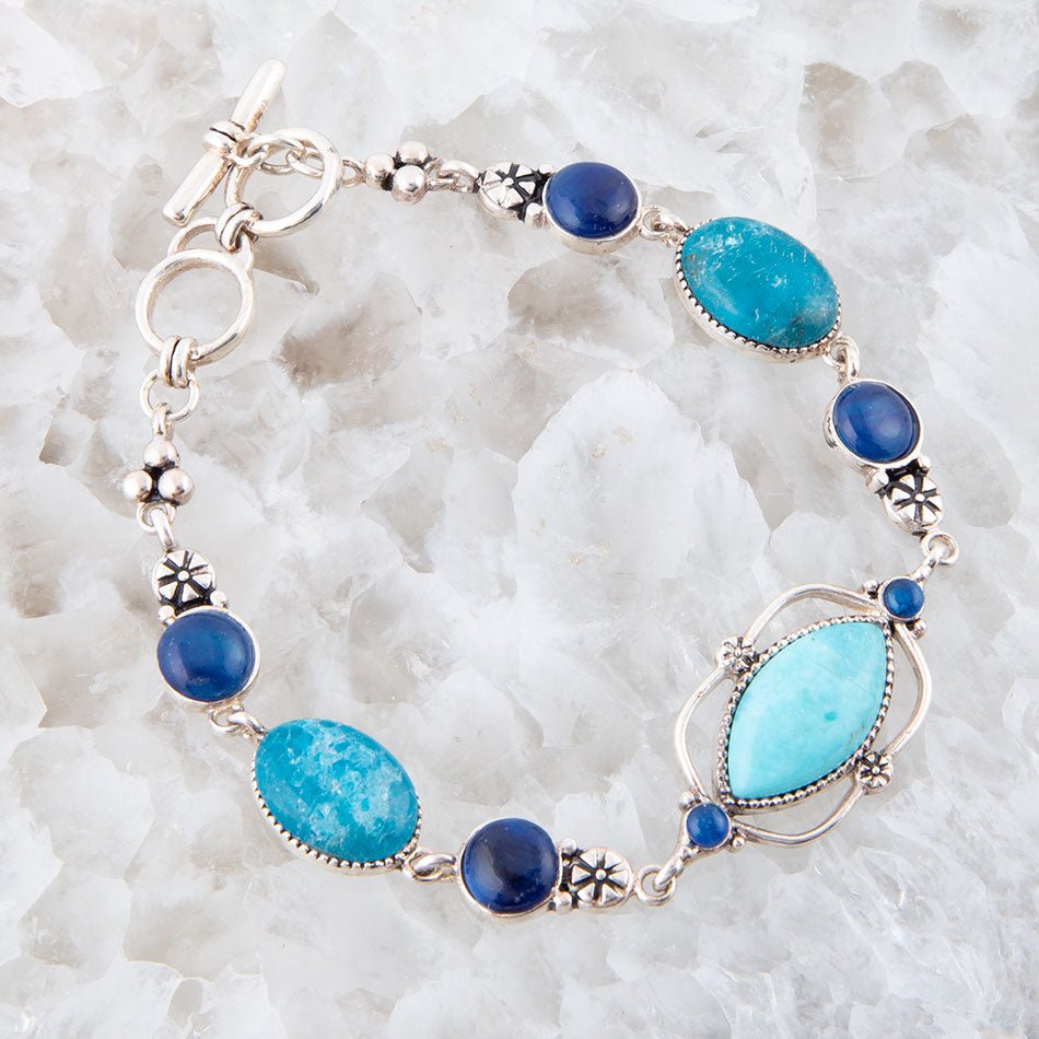 Bracelet with blue and turquoise stones on a white stone background