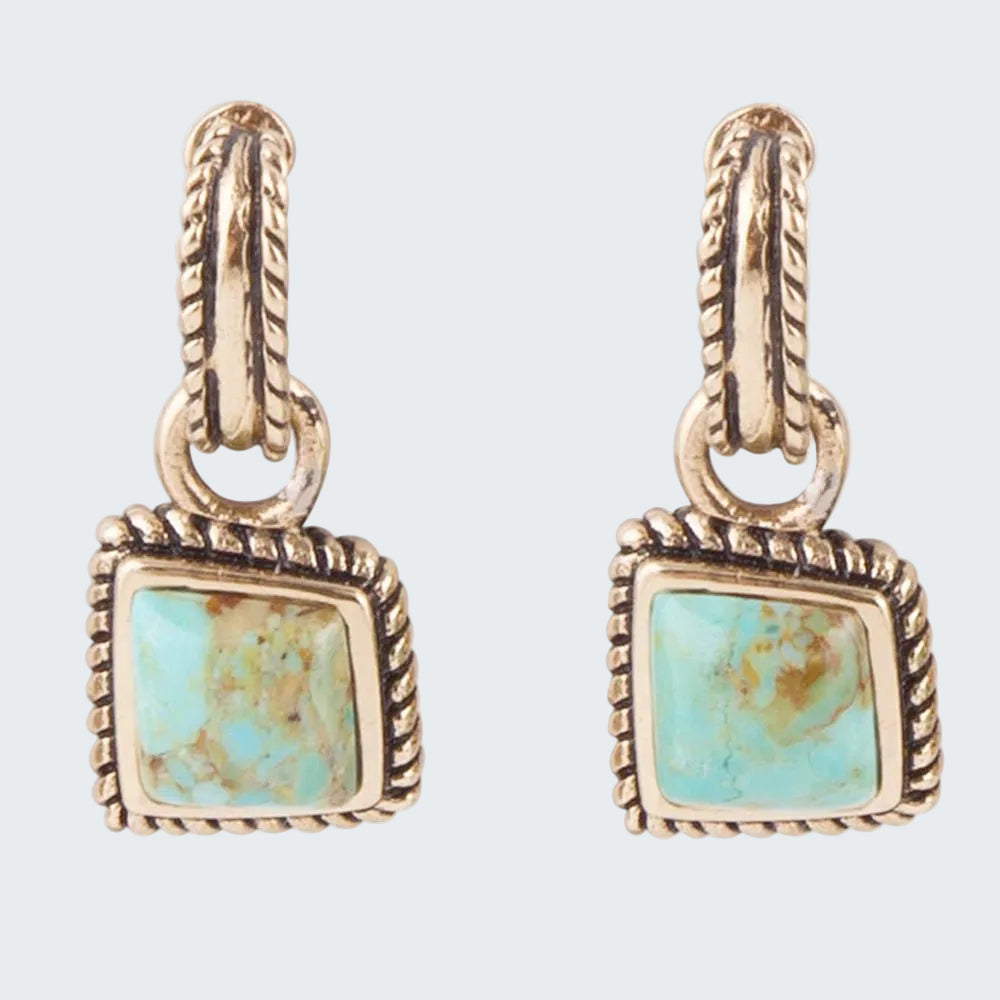 Pair of gold earrings with turquoise stones on a white background