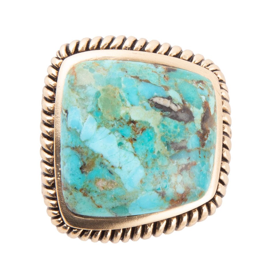 Turquoise stone ring with gold band on a white background