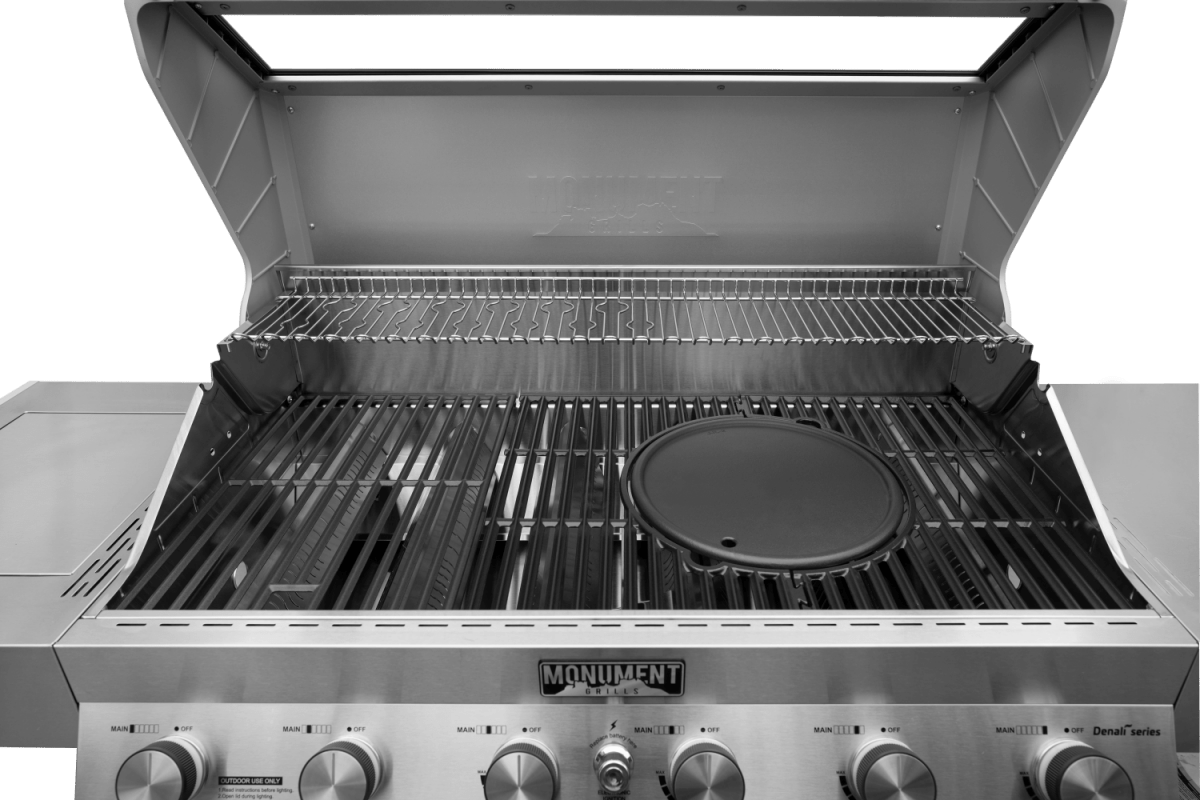 Stainless steel gas grill with visible brand logo on a green background