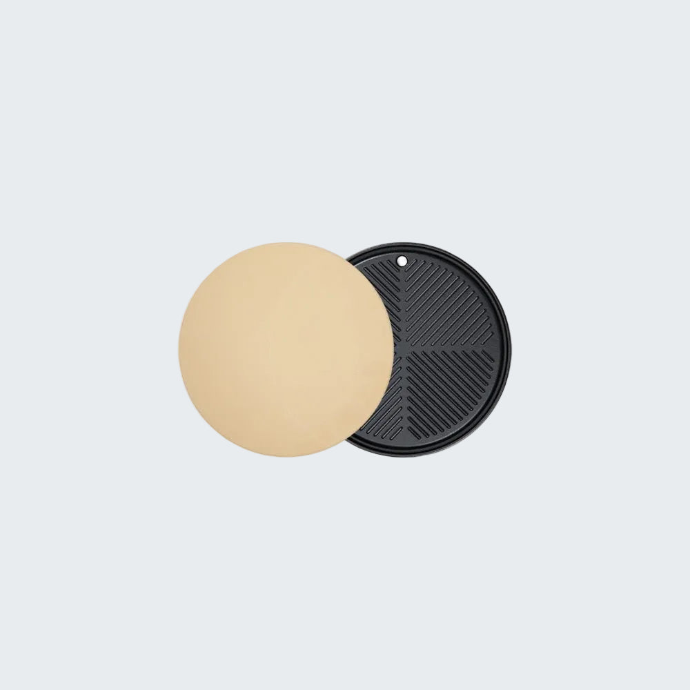 Round beige pad and black textured pad on a light gray background