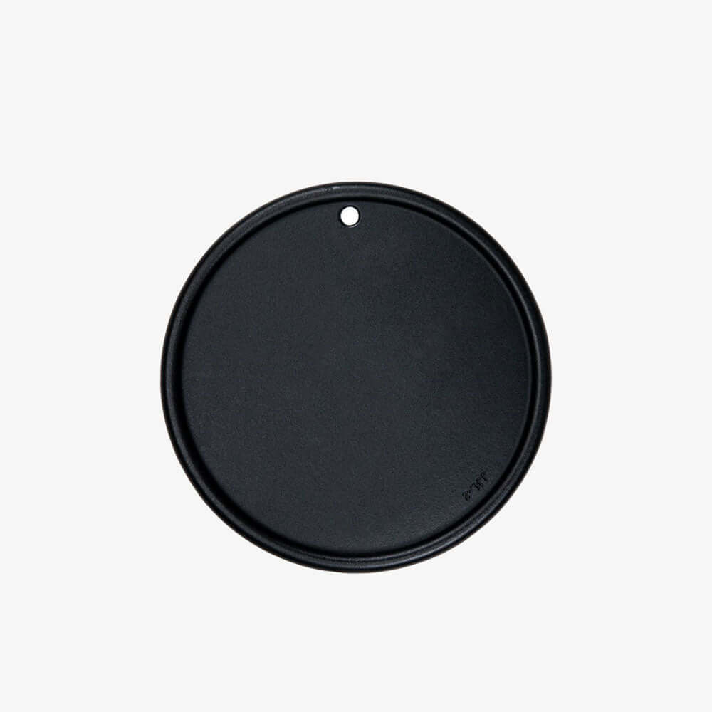 Black round lid on a white background