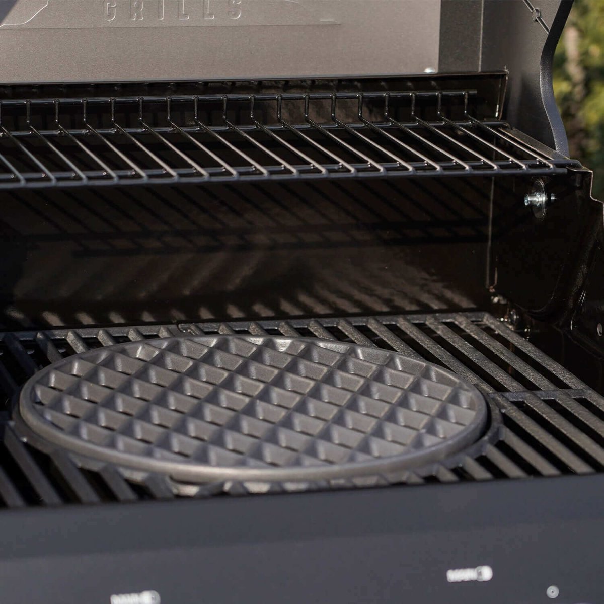 Grill with a waffle plate on one of its burners