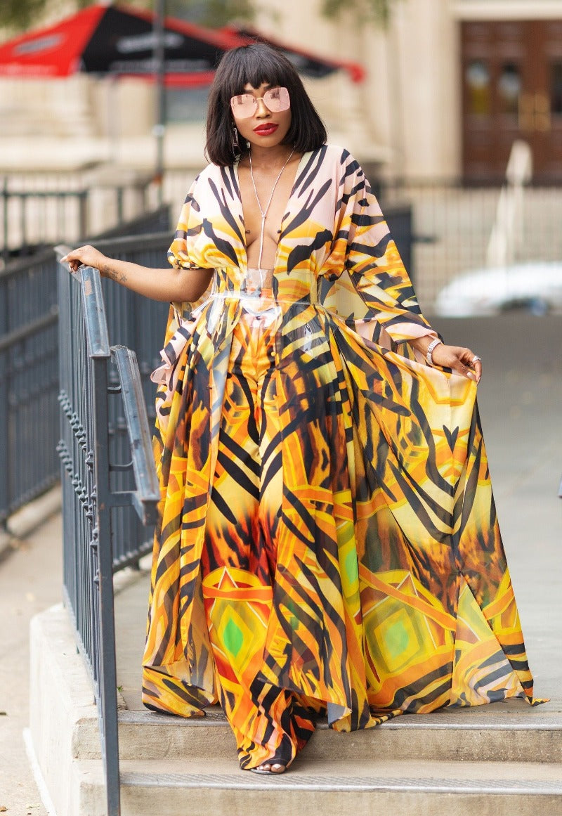Woman in a colorful dress standing on steps outdoors