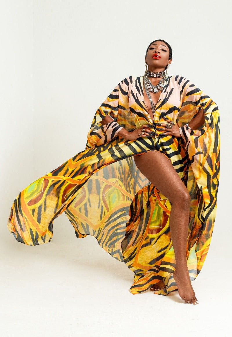 Woman wearing a vibrant, patterned dress on a white background