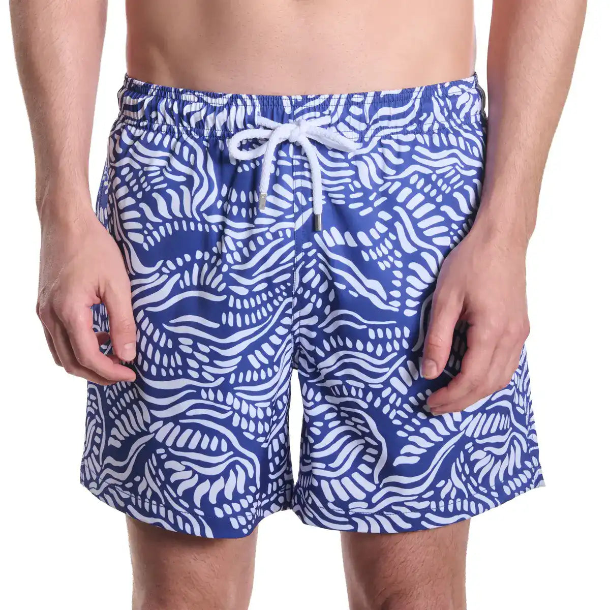 Blue and white patterned swim shorts on a person against a white background