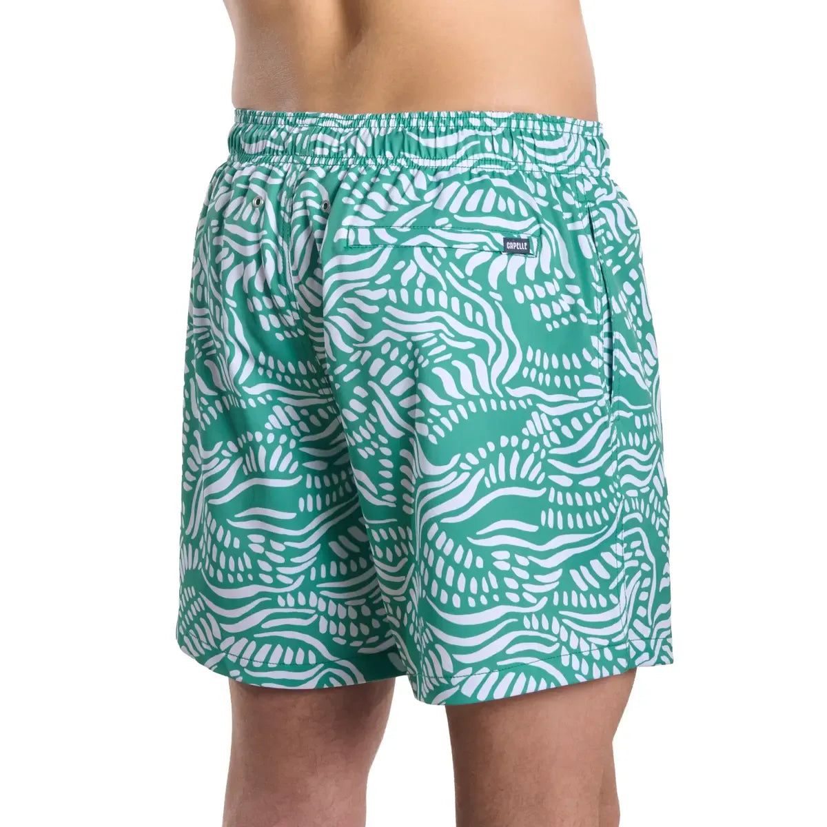 Green and white patterned swim shorts on a white background