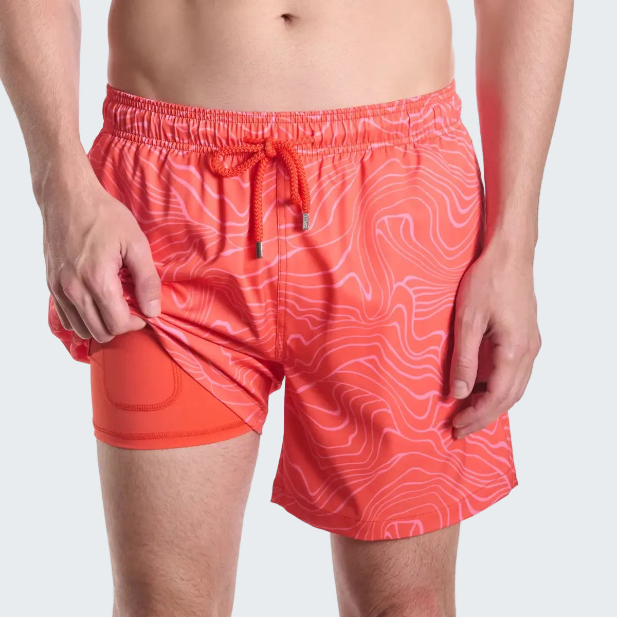 Red swim shorts with a pattern on a white background