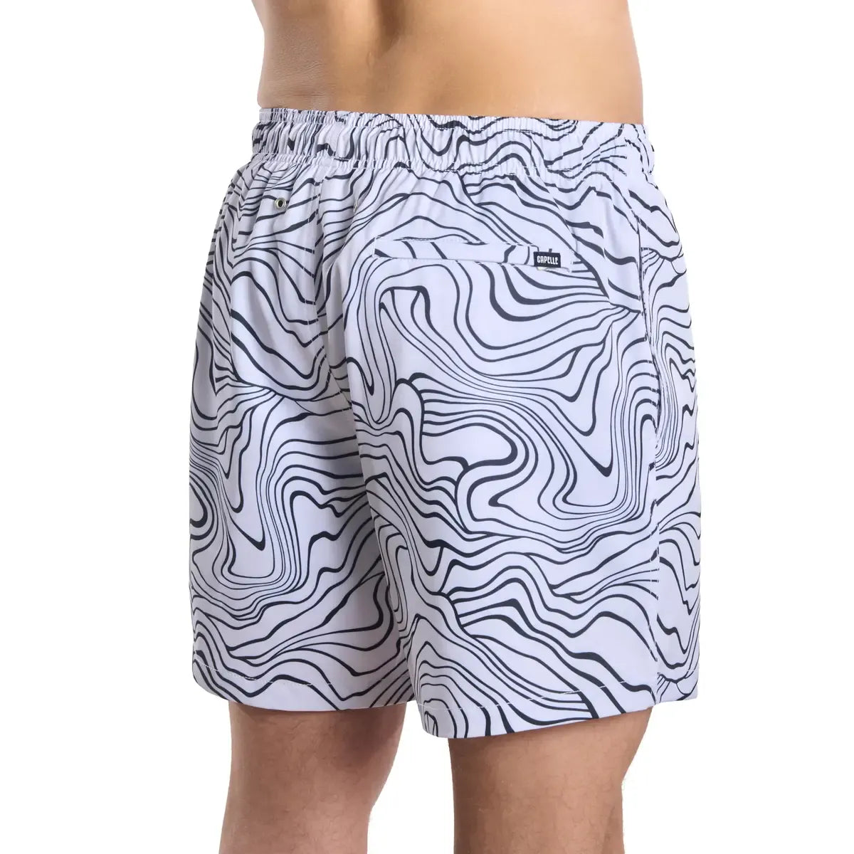 White shorts with black wavy pattern worn by a person on a white background