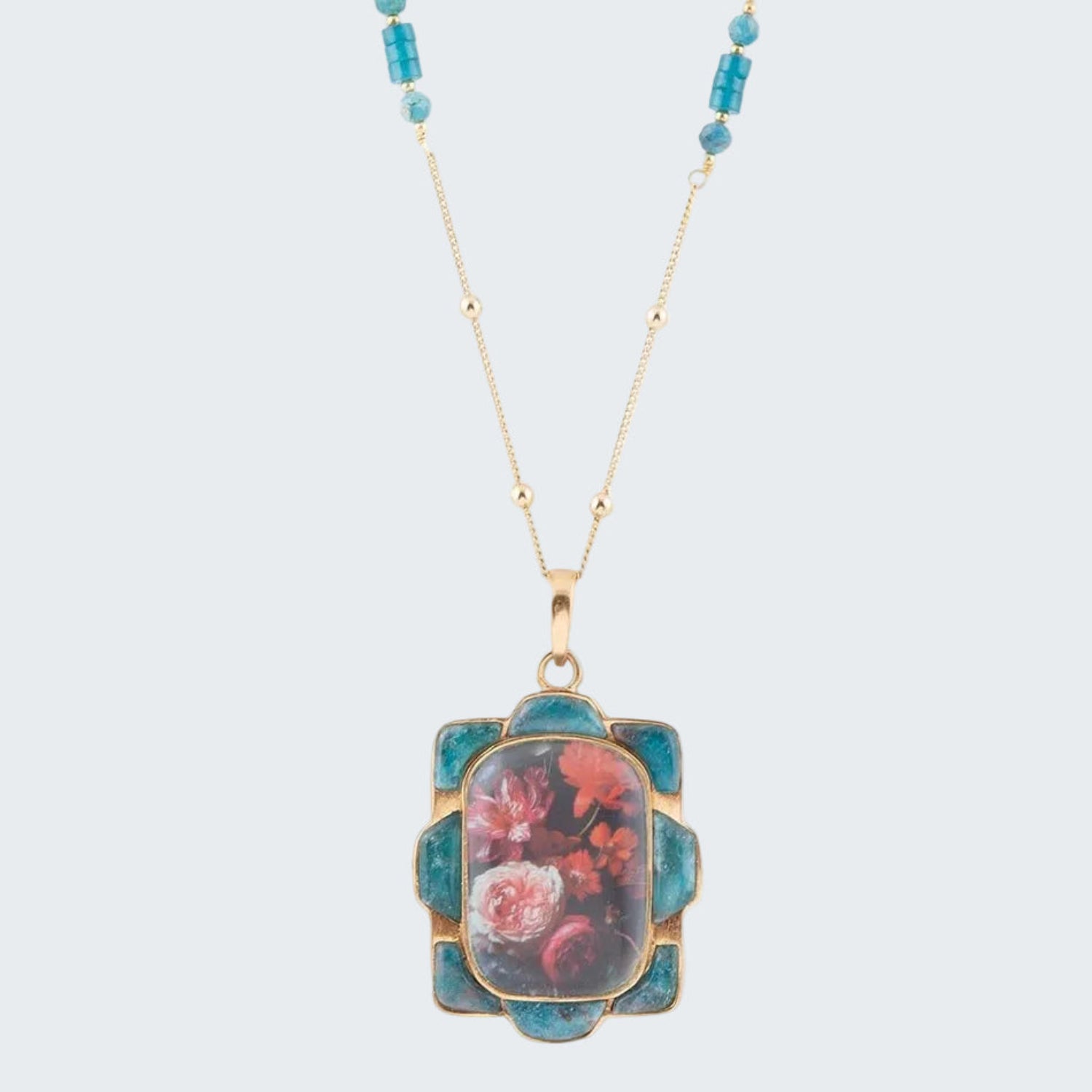 Necklace with a floral pendant and turquoise beads on a white background