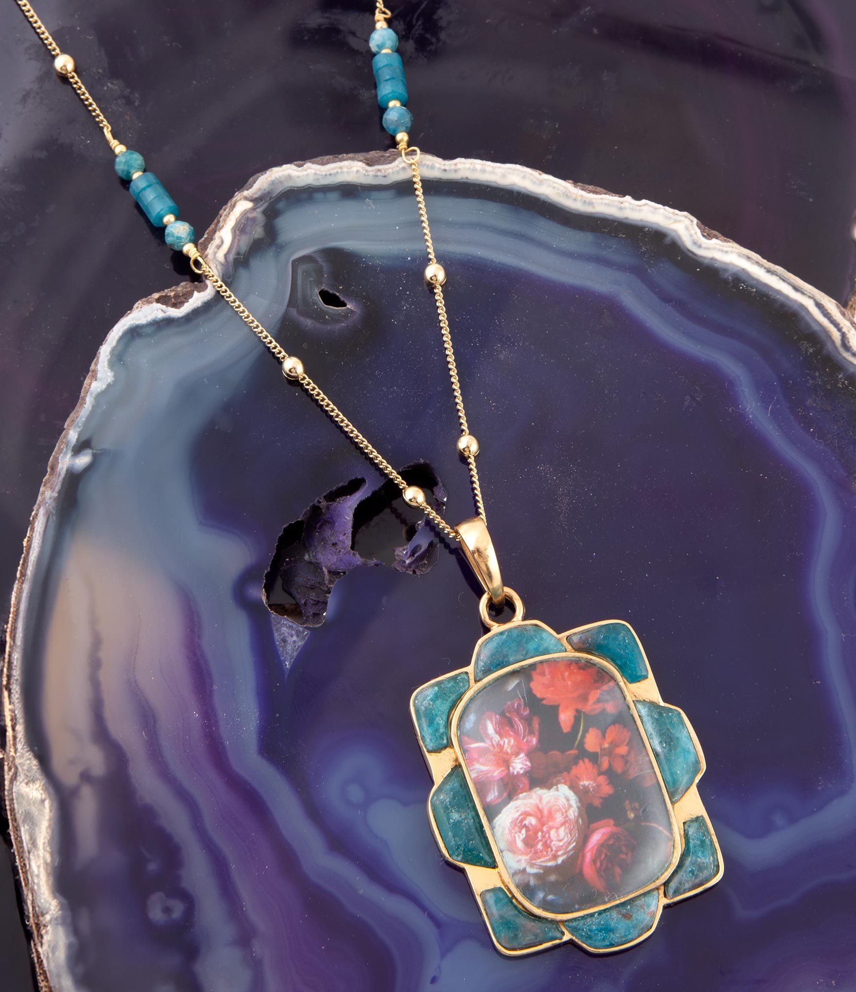 Decorative pendant necklace on a dark, textured surface