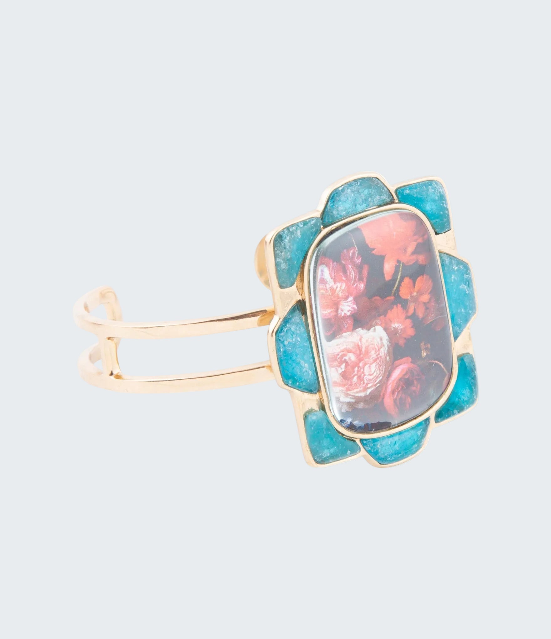 Ring with floral design and turquoise stone on a white background