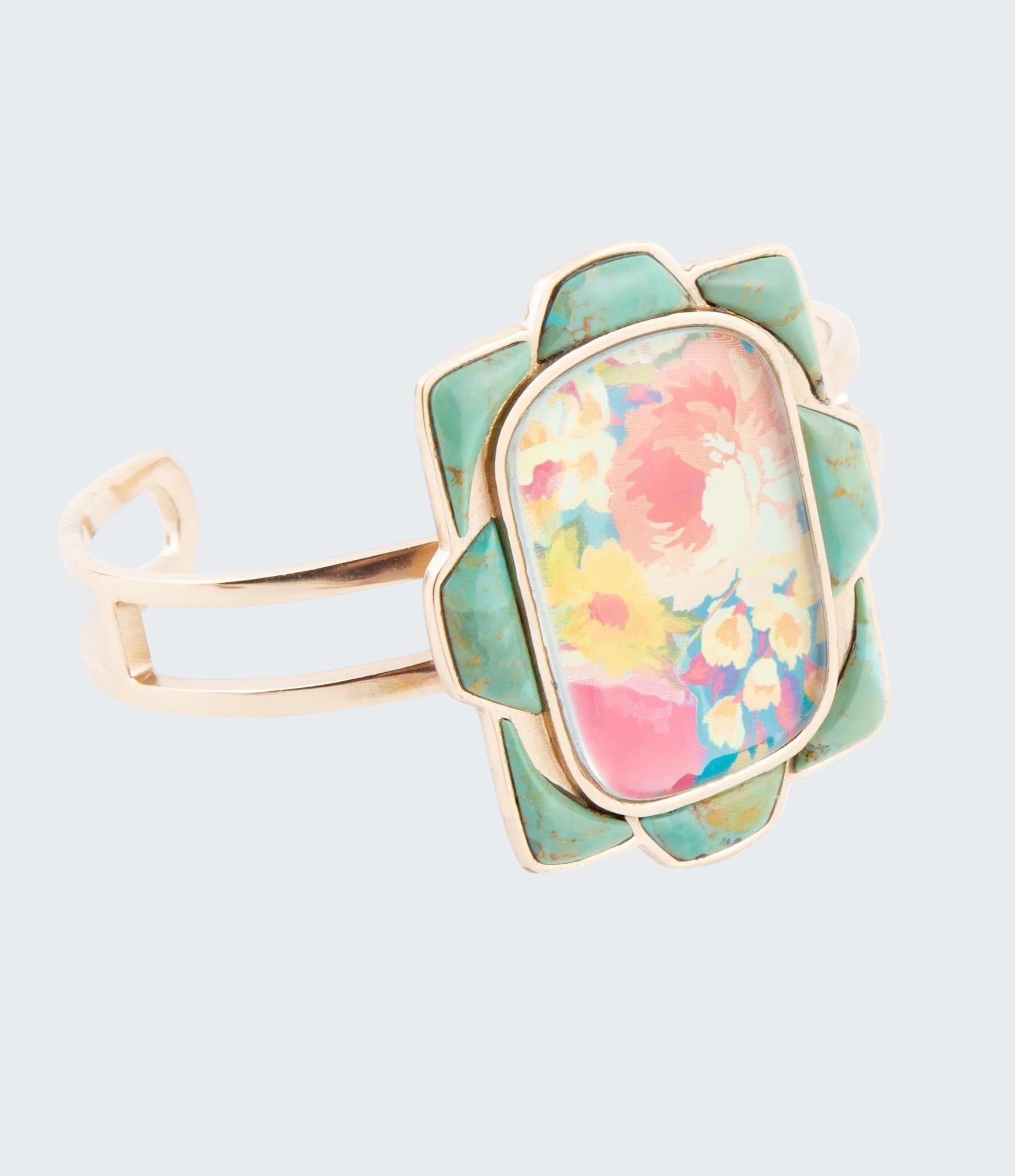 Ring with floral design and gold accents on a white background