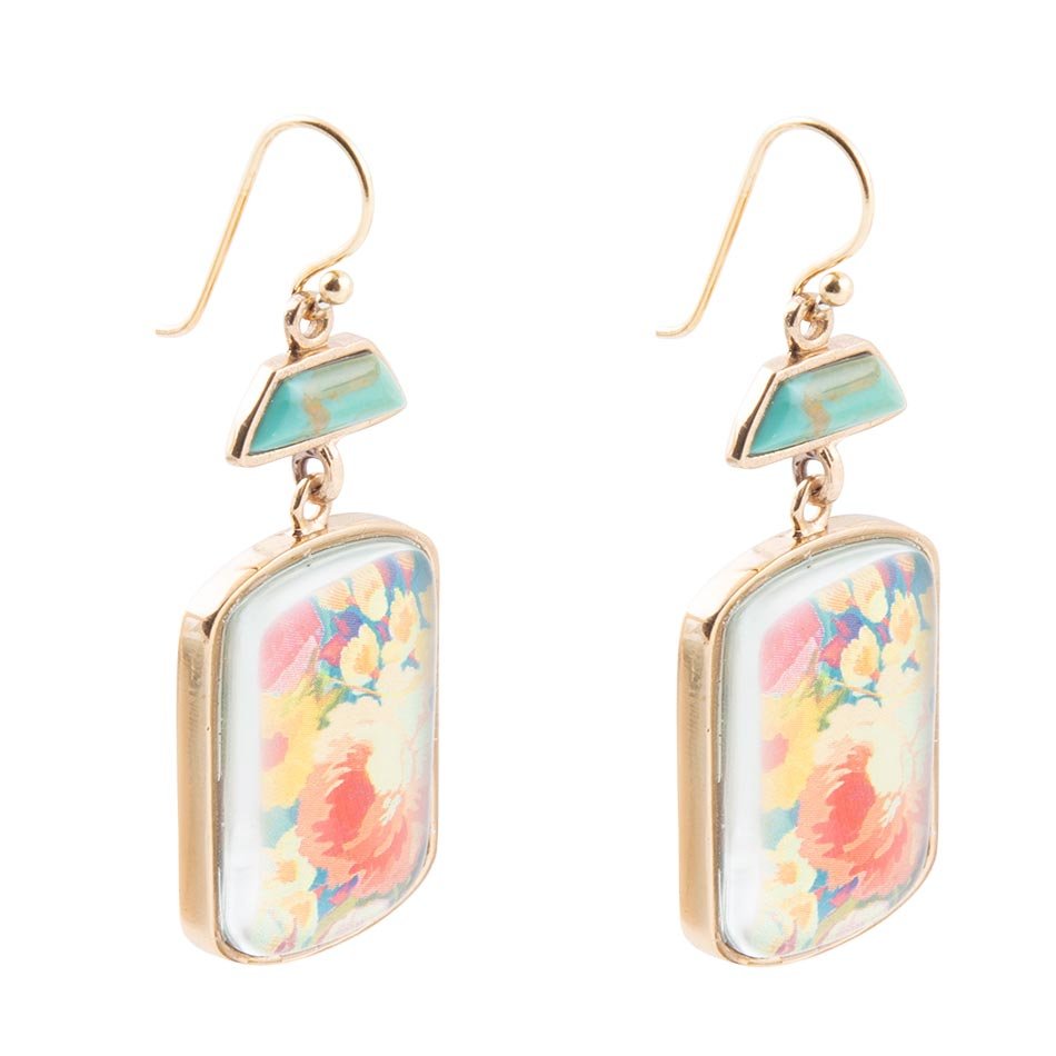 Pair of floral earrings with gold accents on a white background