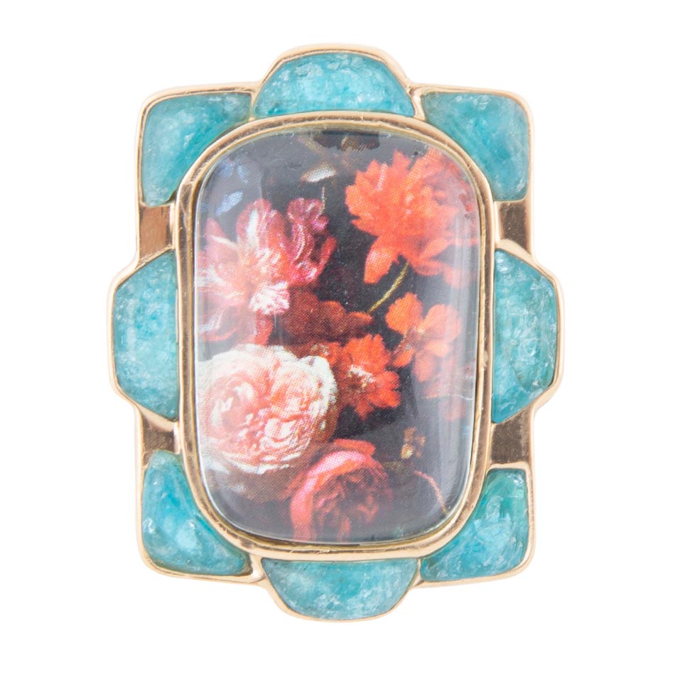 Ring with turquoise stone and floral design on a white background