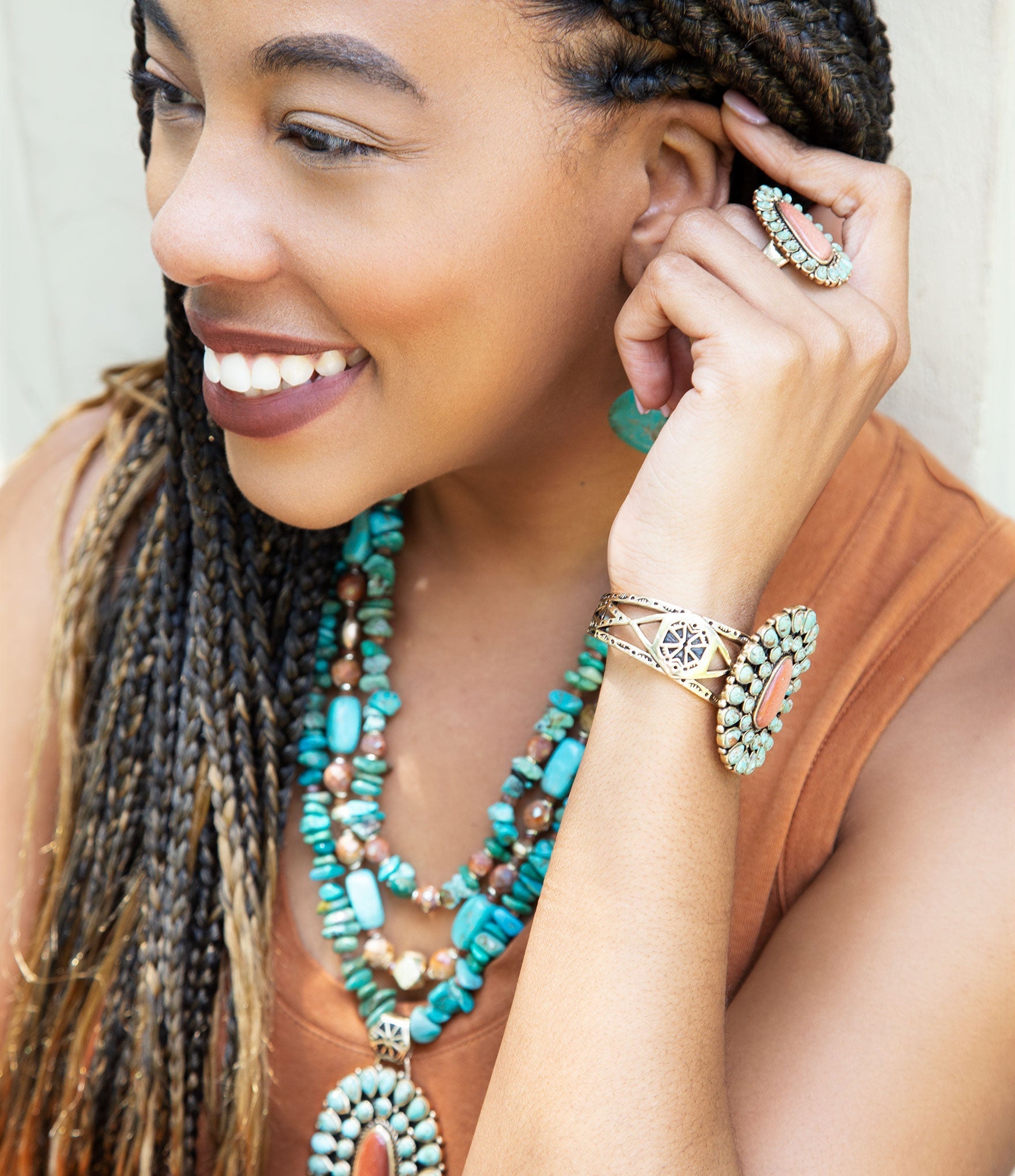 Woman wearing turquoise jewelry including a necklace, earrings, and bracelet.